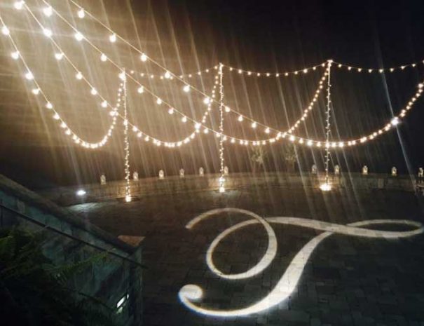Back porch at night with initial projected onto floor